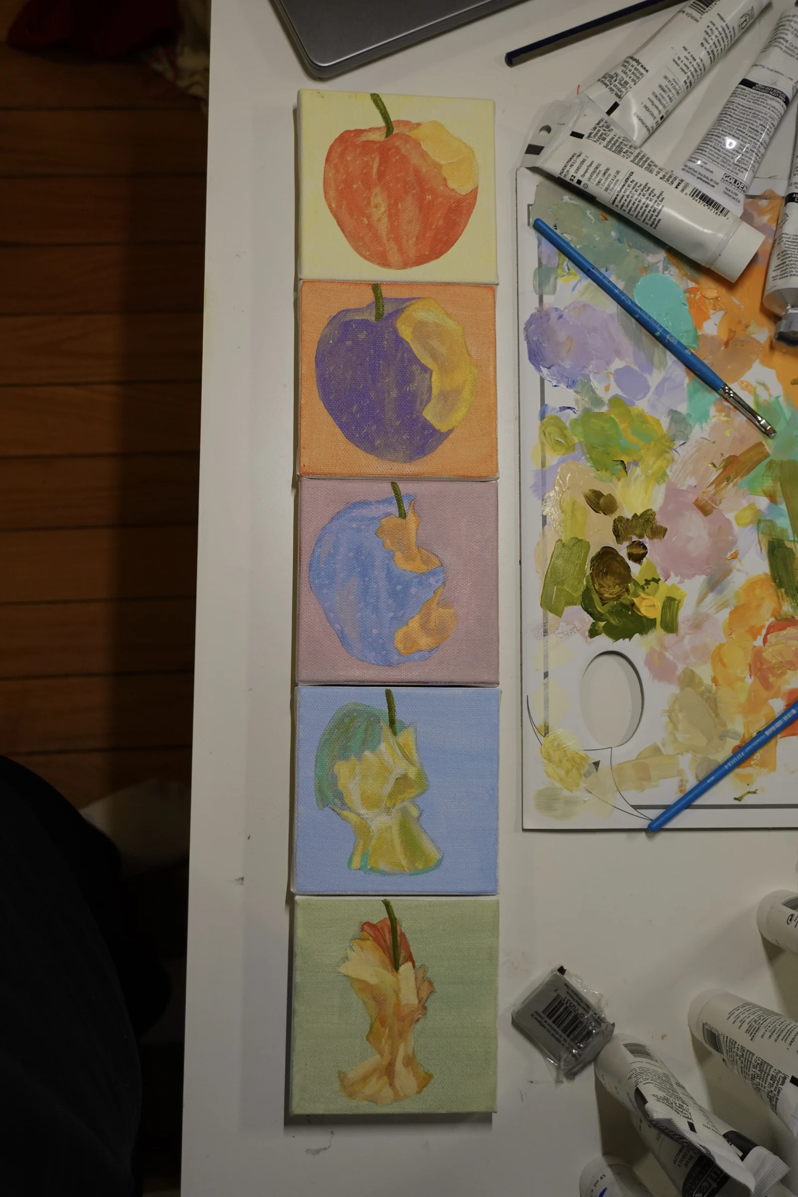 Small acrylic study showing an apple gradually being eaten