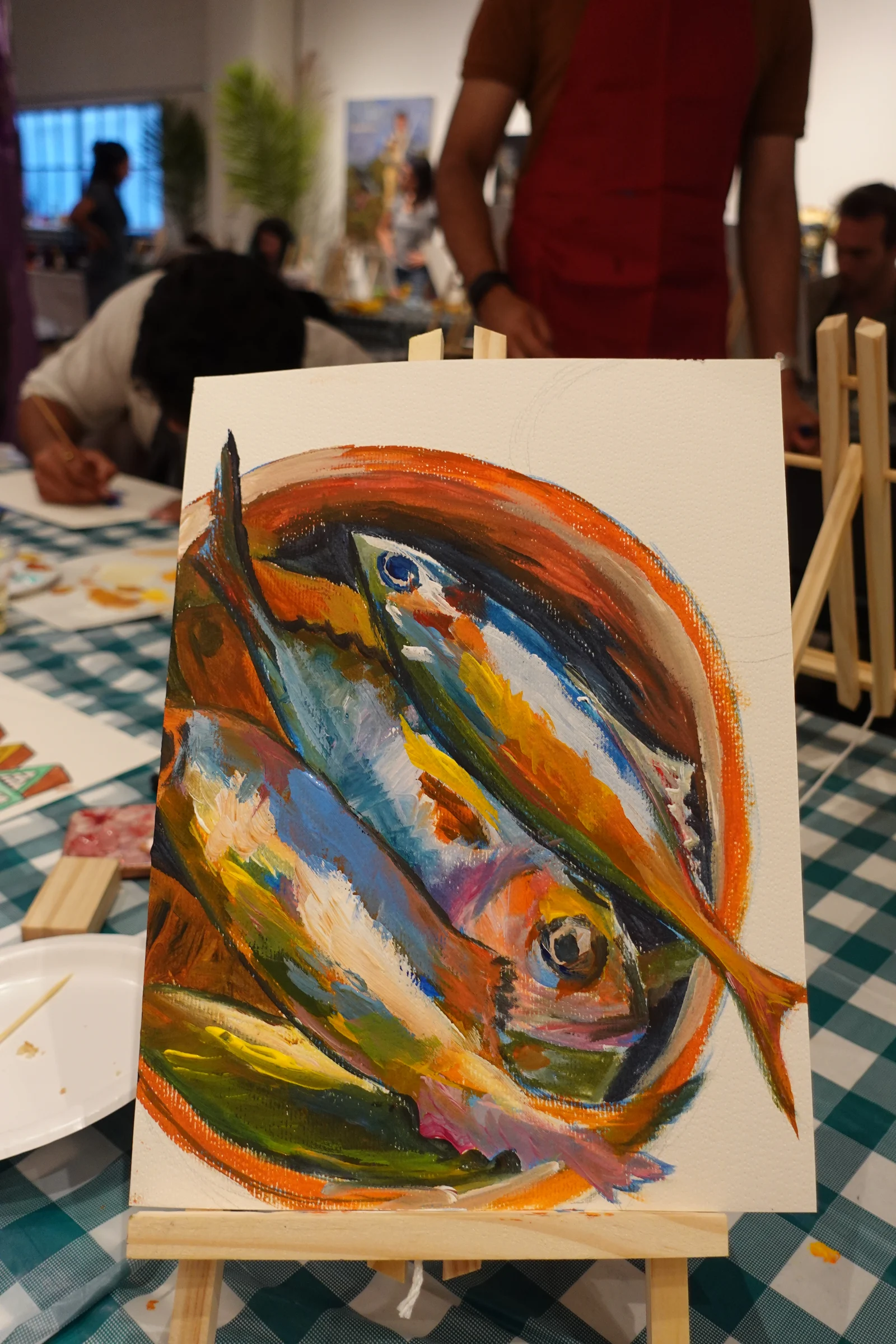 Colorful acrylic fish painting photographed at a painting event